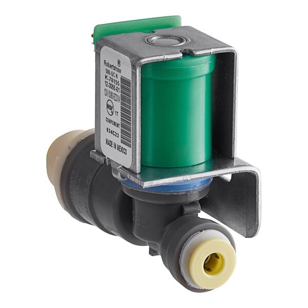 A close up of a Scotsman water inlet valve with a green plastic cover.
