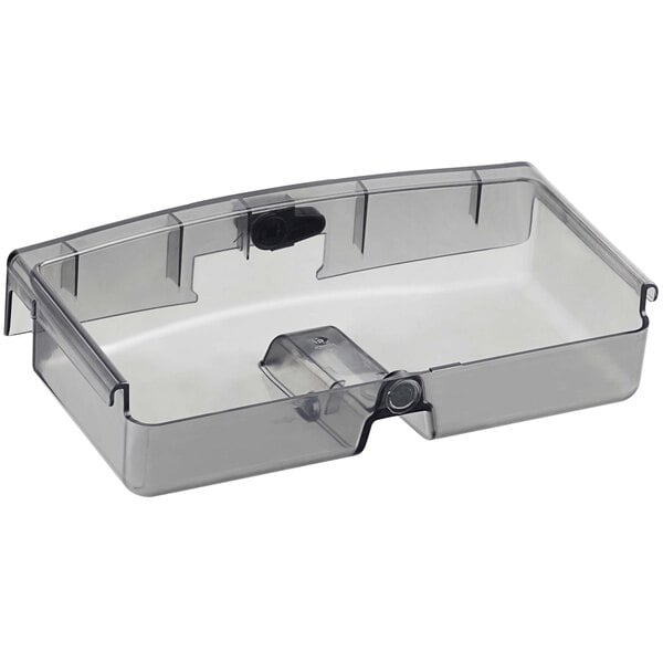 A clear plastic juice container with a black handle.