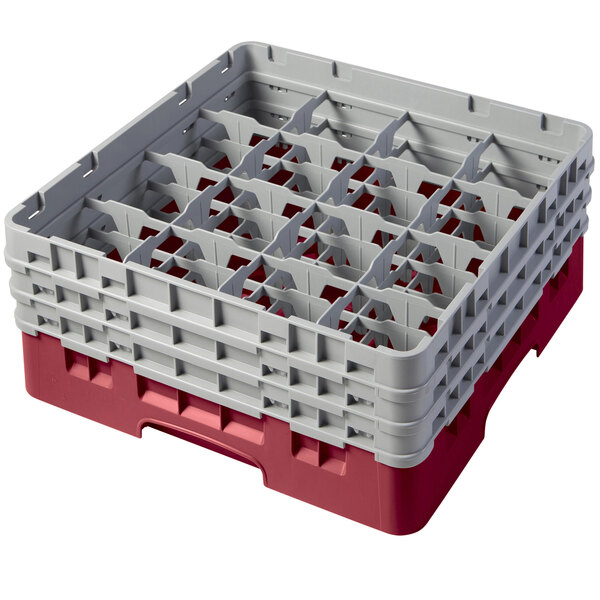 A red plastic Cambro glass rack with compartments and extenders.