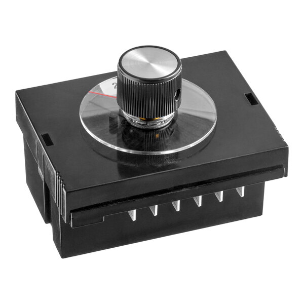 A black rectangular electronic component with a large round control knob and visible metal pins on the bottom.