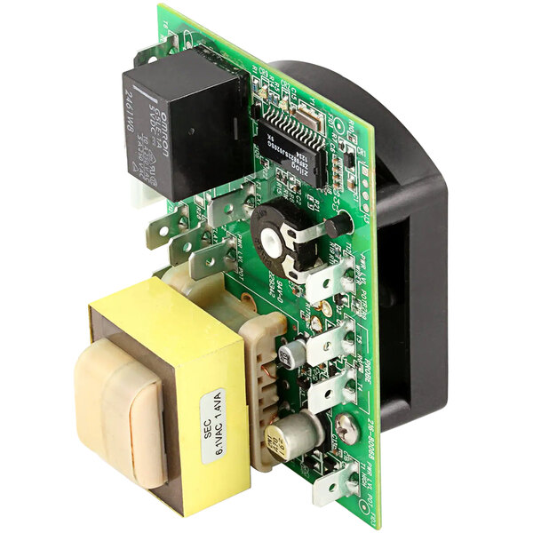 A close-up of the Bakers Pride AS-M1553A thermostat's green circuit board with a yellow square object.