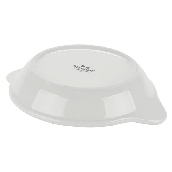 A white bowl with a handle and a lid.