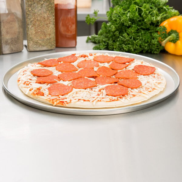 An American Metalcraft deep dish pizza on a tin-plated steel pan with pepperoni and cheese.