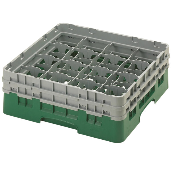 A green and grey plastic Cambro glass rack with 16 compartments.