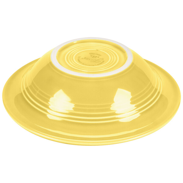 A yellow Fiesta china bowl with a white rim.