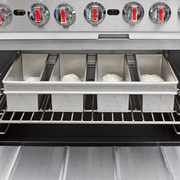 a metal trays with food inside of a oven