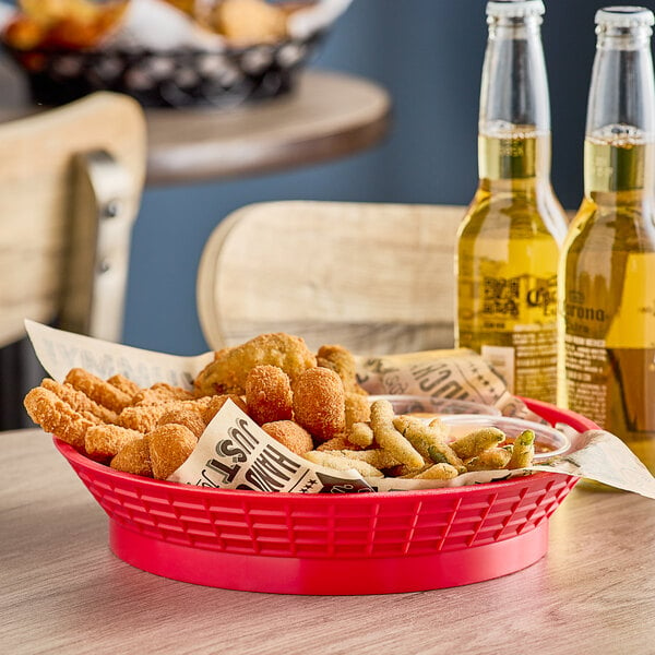 A red Tablecraft plastic diner platter basket filled with fried food.