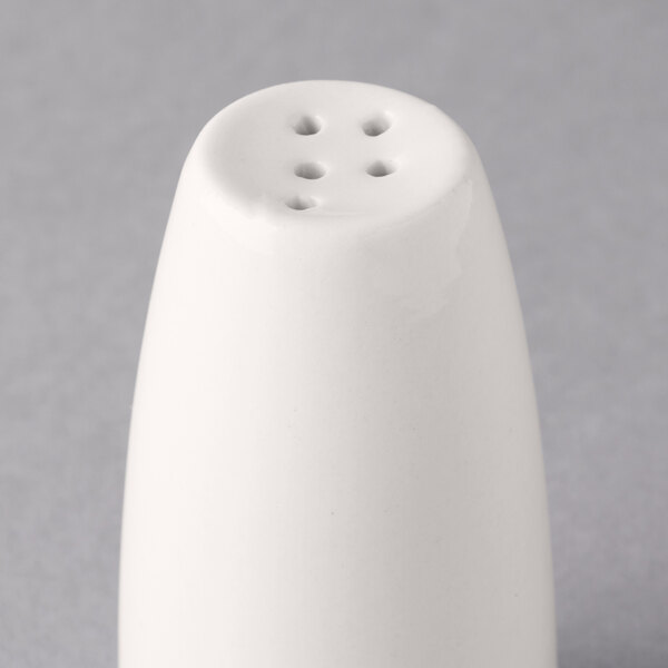 A white Libbey porcelain pepper shaker with holes in it.