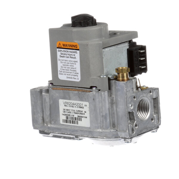 A close-up of a Groen natural gas valve with a grey metal housing and black button.