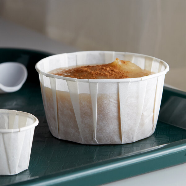 A white tray with two Genpak Harvest paper portion cups filled with food.