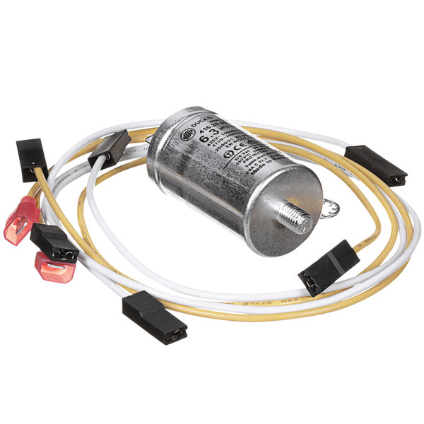 A Moffat capacitor relocation kit with a small metal cylinder and wires around it.