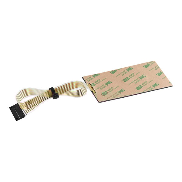A rectangular piece of paper with a small piece of ribbon cable, green and black wires.