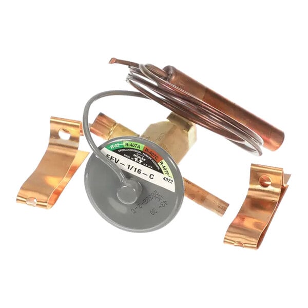 A close-up of a copper tube with a wire attached.