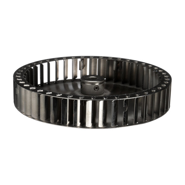 A close-up of a plated metal wheel with holes.
