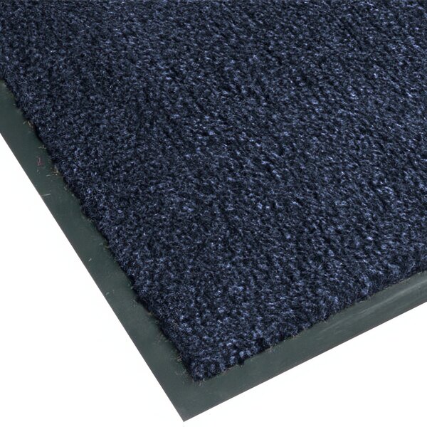 A close-up of a slate blue Notrax carpet with a black border.