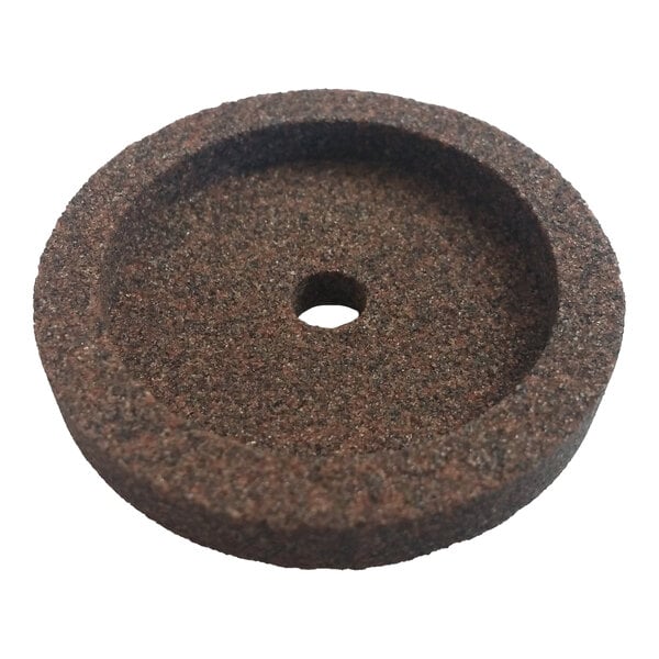A round, coarse-textured sharpening stone with a central hole.