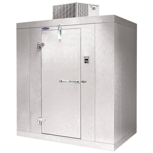 A white metal Norlake Kold Locker walk-in freezer with an open door.