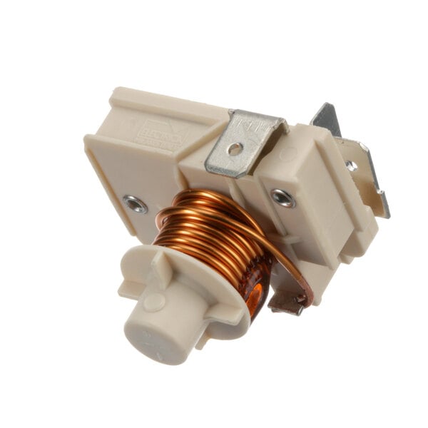 A small white and brown electrical switch with a copper coil.