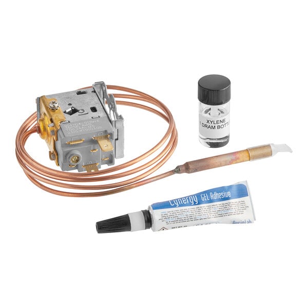 A close-up of a copper and plastic low pressure switch with a tube.