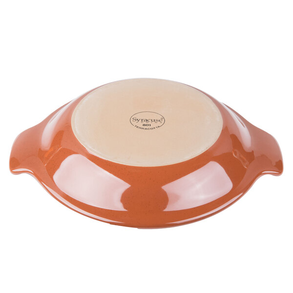 A Libbey terracotta handled baker with a lid.