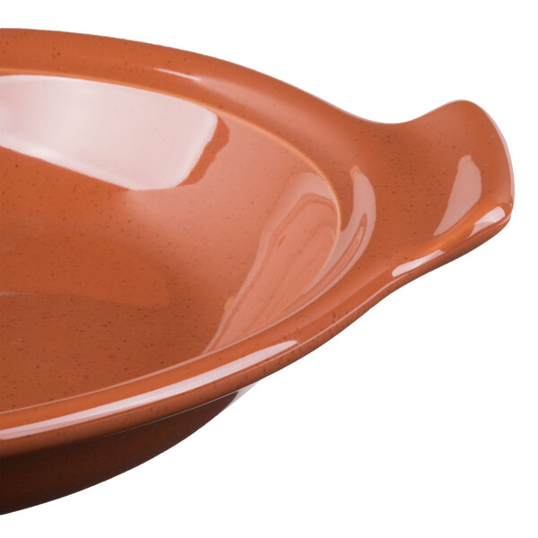 A Libbey terracotta handled baker with a brown rim.