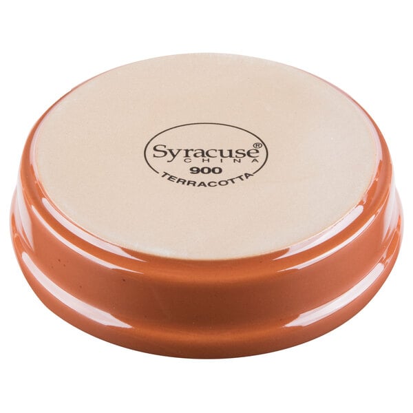 A brown and white Libbey Terracotta cazuela bowl on a table.