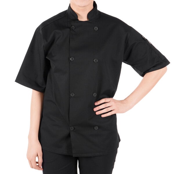 A person wearing a Mercer Culinary black chef coat.