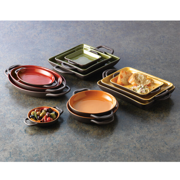 A stack of Libbey Coos Bay stoneware oval bakers with handles.