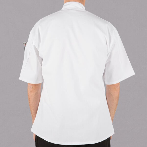 A person wearing a white Mercer Culinary Millennia cook jacket.