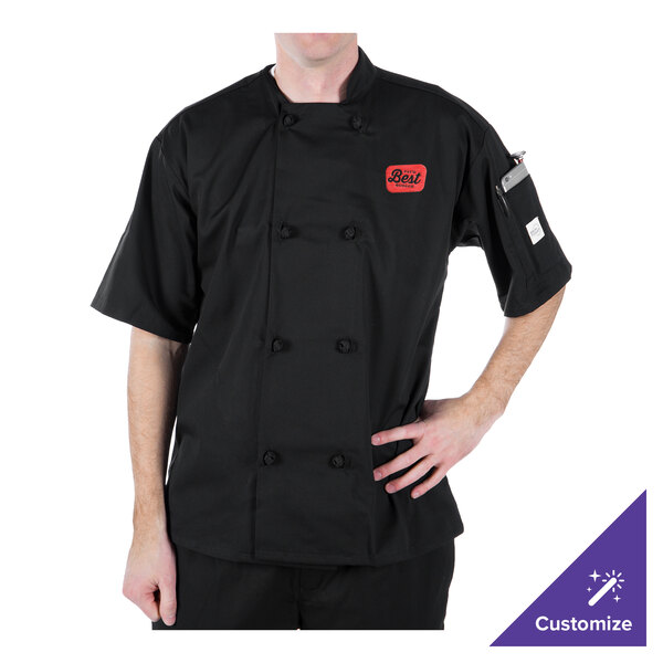 A man wearing a black Mercer Culinary chef coat with knot buttons.