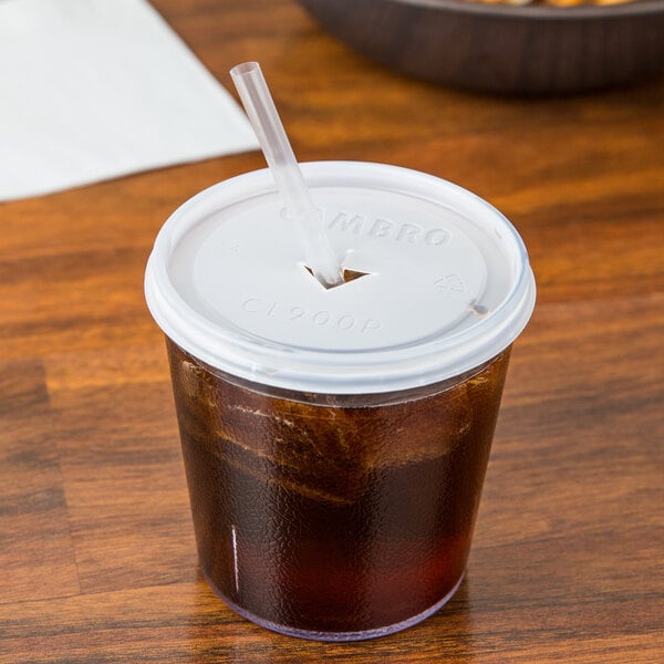 A clear plastic Cambro tumbler with a straw in it.