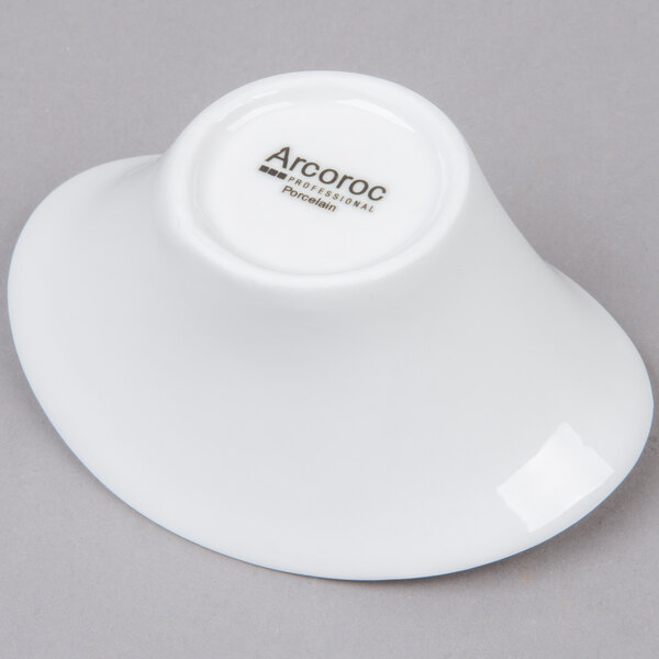 An Arcoroc white porcelain deep oval bowl with the word Arco in black.