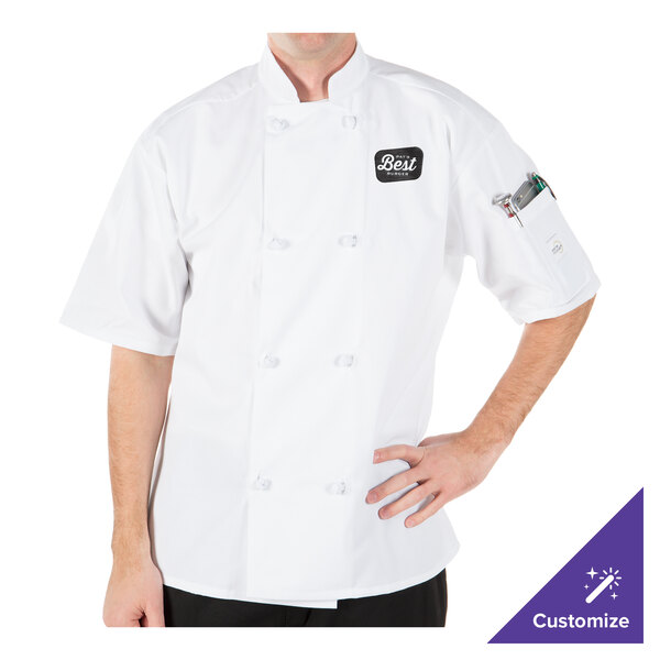 A man wearing a Mercer Culinary white chef jacket with cloth knot buttons.