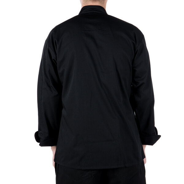 A man wearing a Mercer Culinary black long sleeve chef jacket.