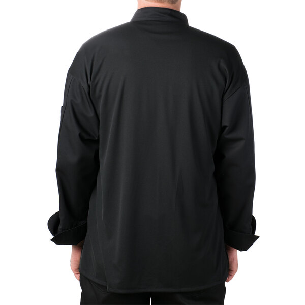 The back of a man wearing a black Mercer Culinary Millennia Air chef jacket with full mesh back.