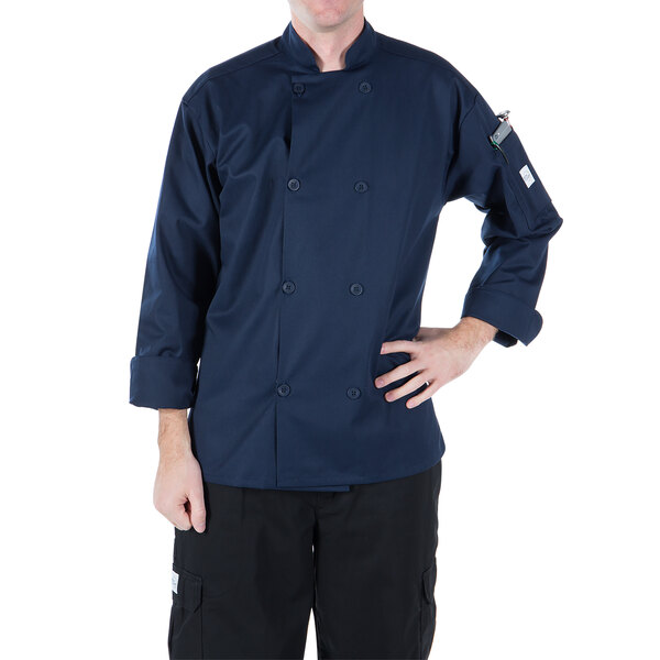 A man wearing a Mercer Culinary Millennia navy chef coat.