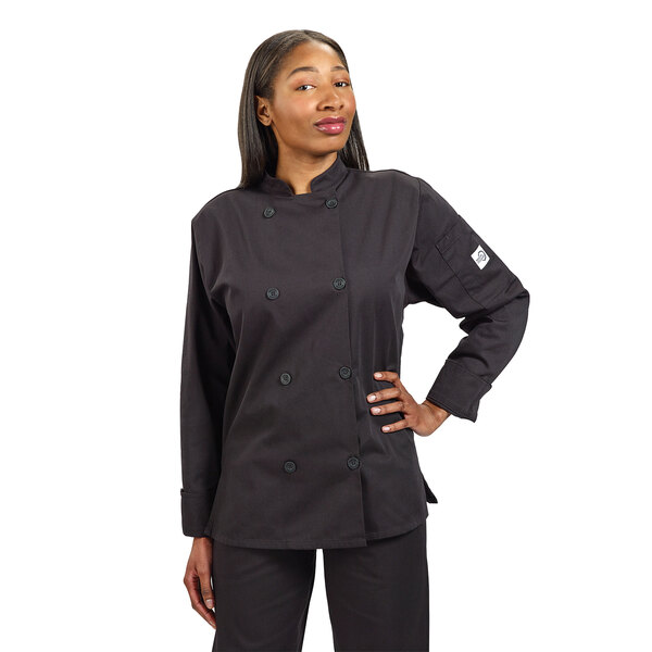 A woman wearing a black Mercer Culinary Millennia chef coat with long sleeves.