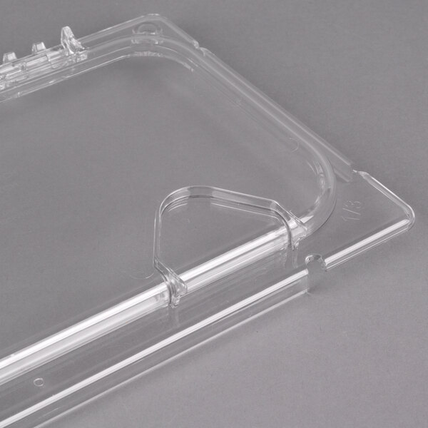 A clear plastic Carlisle food pan lid with 2 notches.