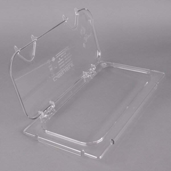 A Carlisle clear polycarbonate food pan lid with a notch on a clear plastic food pan.