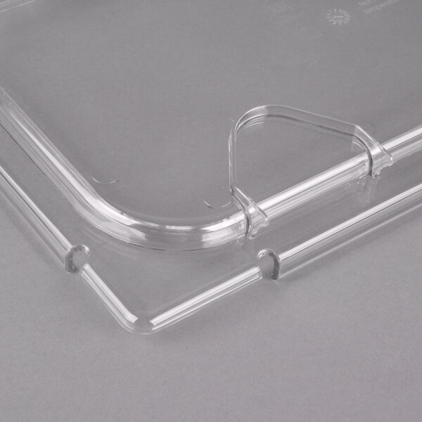 A clear plastic food pan lid with a notch.