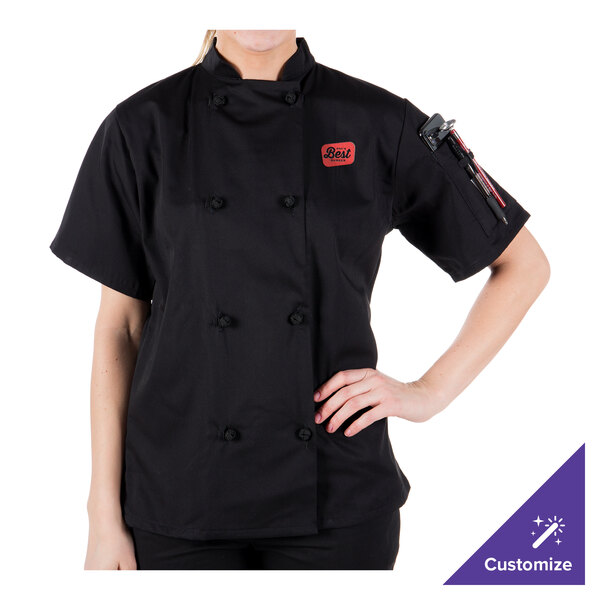 A woman wearing a Mercer Culinary chef jacket with cloth knot buttons.