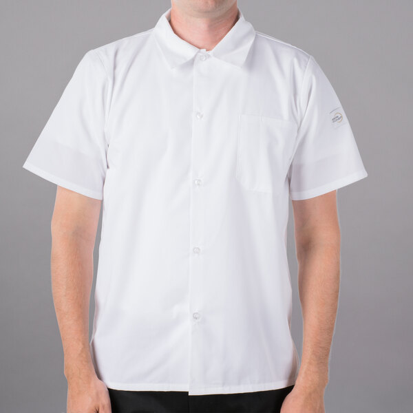 A man wearing a Mercer Culinary Millennia white cook shirt with full mesh back.