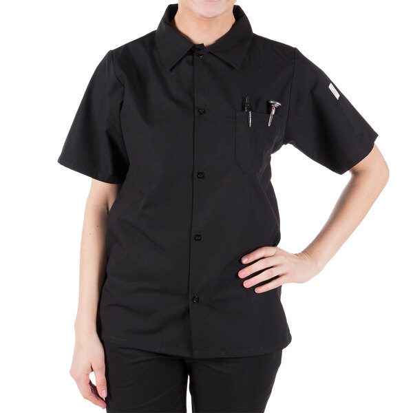 A woman wearing a black Mercer Culinary cook shirt.