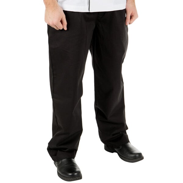 A person wearing Mercer Culinary black chef pants and a white shirt.