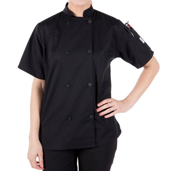 A woman wearing a black Mercer Culinary chef coat.