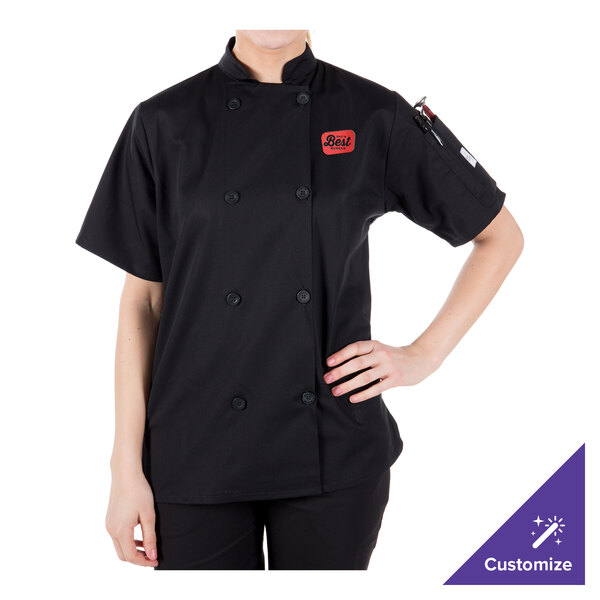 A woman wearing a black Mercer Culinary chef jacket.