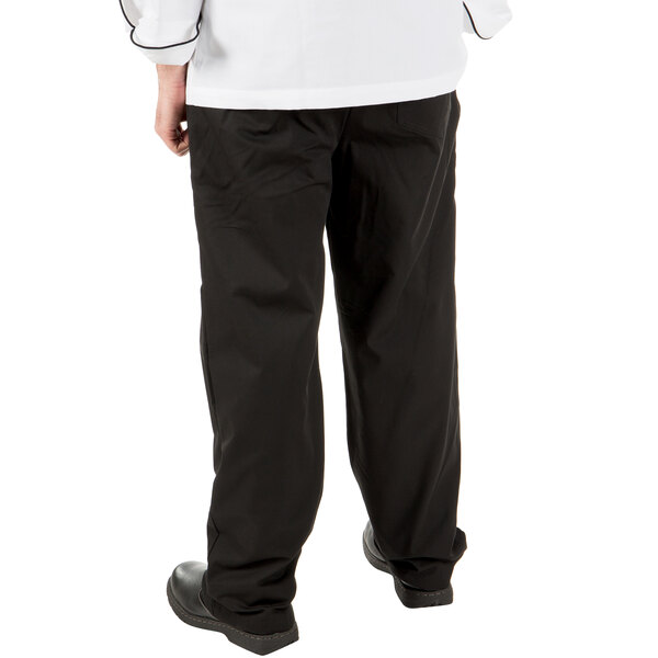 A person wearing Mercer Culinary Millennia black chef pants.