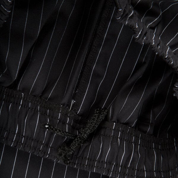 Mercer Culinary Millennia unisex black pinstripe chef pants. A close up of black and white pinstripe fabric.