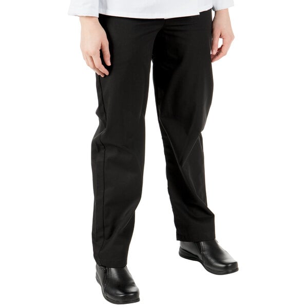 A woman wearing Mercer Culinary Millennia black chef pants.