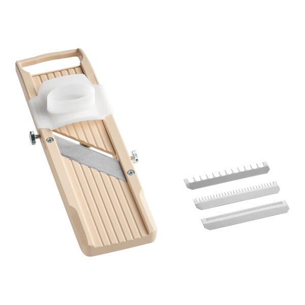 A beige Japanese mandoline slicer with a hand guard and three interchangeable blades.
